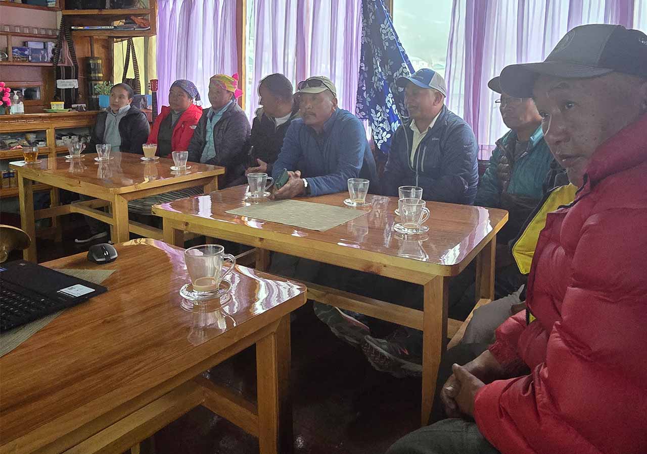 A group of people sit at tables.