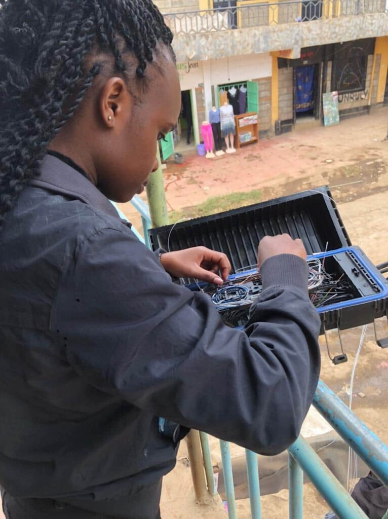 a woman on a balcony working on some cables