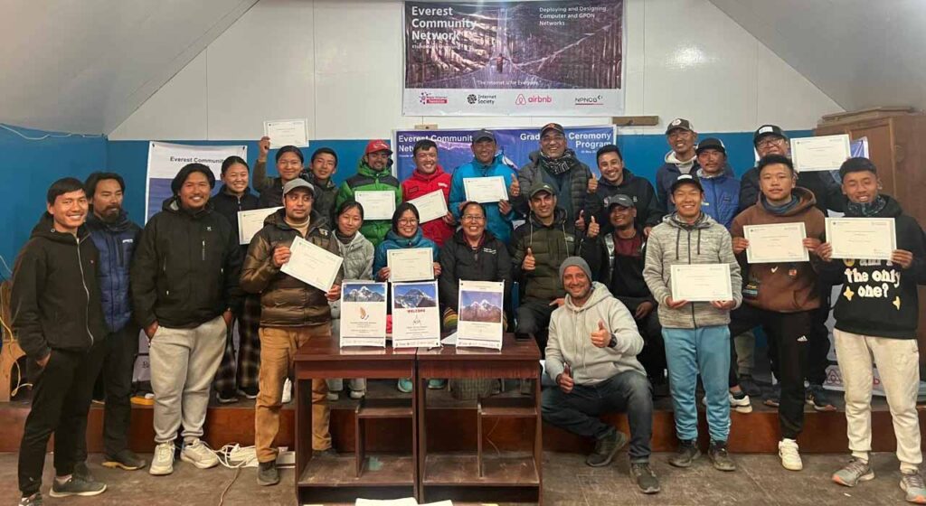 A group photo of the class holding certificates and smiling.