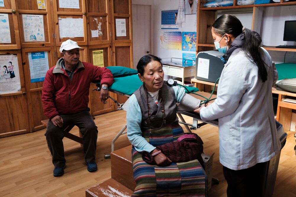 A doctor measuring blood pressure of a patient