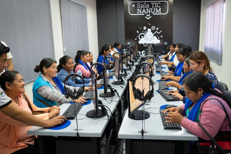 a group of women surfing the Internet in a huge conference room