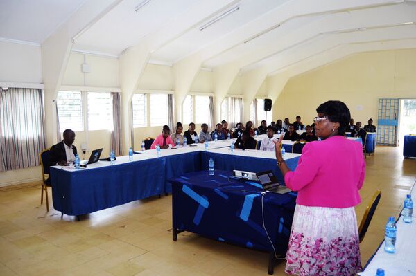 a woman teacher explaining to a group of students