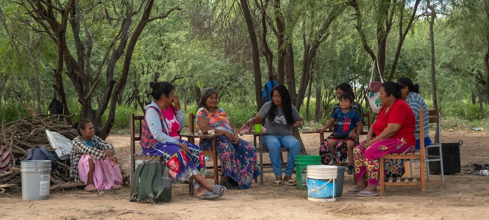 a group of woman sitting outside